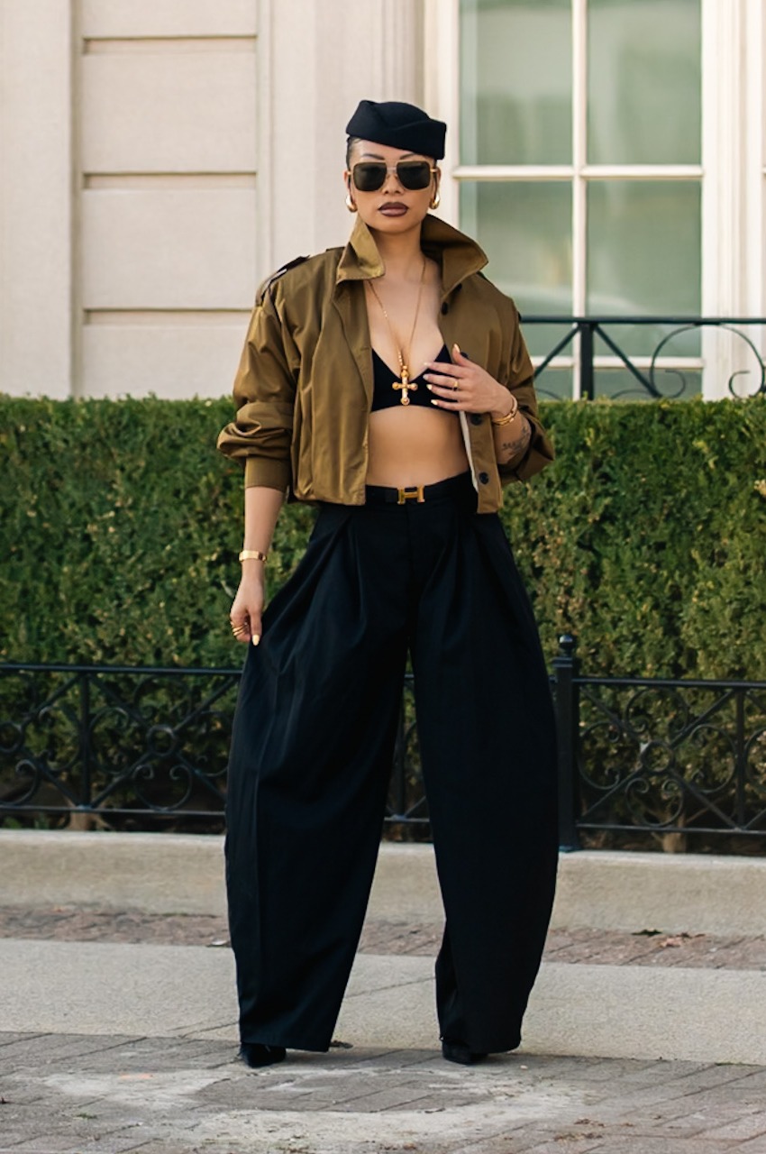 Glo, founder of Gloluxstyle, in a tailored black-and-olive look